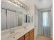 The bathroom features a double sink vanity with a large mirror at 18590 W Vogel Ave, Goodyear, AZ 85338