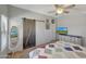 The bedroom features a sliding barn door and a dresser with a TV at 18590 W Vogel Ave, Goodyear, AZ 85338