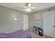 Bedroom featuring a ceiling fan, closet, small storage, and a bed with purple cover at 18590 W Vogel Ave, Goodyear, AZ 85338
