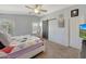 This bedroom features a sliding barn door, soft carpet, and a light ceiling fan at 18590 W Vogel Ave, Goodyear, AZ 85338