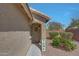 Entryway view of home featuring desert landscaping, a covered porch, and a decorative wreath on the front door at 18590 W Vogel Ave, Goodyear, AZ 85338