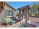 Cozy front porch area with comfortable seating, desert landscaping, and a charming covered entrance at 18590 W Vogel Ave, Goodyear, AZ 85338