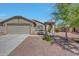 Inviting single-story home featuring a low maintenance yard, covered porch entry, and attached two car garage at 18590 W Vogel Ave, Goodyear, AZ 85338