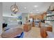 Open kitchen with stainless appliances flows into the adjacent living area, perfect for modern living at 18590 W Vogel Ave, Goodyear, AZ 85338