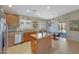 Bright kitchen boasts a practical island and stainless steel appliances, offering both style and functionality at 18590 W Vogel Ave, Goodyear, AZ 85338
