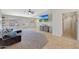 Open living area with modern ceiling fan, tile floors, and comfortable sofa with a view of a wall mounted television at 18590 W Vogel Ave, Goodyear, AZ 85338