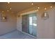 Covered patio with sliding glass doors and ambient string lights for relaxed outdoor living at 18590 W Vogel Ave, Goodyear, AZ 85338