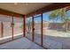 Enclosed sunroom with brick accent wall overlooking the backyard at 18590 W Vogel Ave, Goodyear, AZ 85338