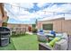 Inviting backyard with artificial grass, outdoor seating, a grill, and string lights, perfect for entertaining at 18650 N 91St Ave # 3701, Peoria, AZ 85382