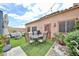Charming backyard featuring outdoor seating, a grill, lush plants, and decorative stones for relaxing and dining at 18650 N 91St Ave # 3701, Peoria, AZ 85382