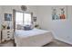 Cozy bedroom featuring a comfortable bed, decorative pillows, and natural light from a large window at 18650 N 91St Ave # 3701, Peoria, AZ 85382