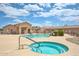 Relaxing community pool area with a hot tub, swimming pool, shaded seating, and beautifully kept grounds at 18650 N 91St Ave # 3701, Peoria, AZ 85382
