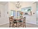 Open-concept dining area with a wooden table set, chandelier, and an opening looking into the kitchen at 18650 N 91St Ave # 3701, Peoria, AZ 85382