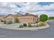 Charming exterior elevation showcasing desert landscaping, a well-maintained yard, and an attached two-car garage at 18650 N 91St Ave # 3701, Peoria, AZ 85382