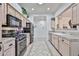 Kitchen featuring neutral cabinetry, tile countertops, updated appliances, and an open view to the dining room at 18650 N 91St Ave # 3701, Peoria, AZ 85382
