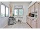Eat-in kitchen area with custom cabinets, drink refrigerator, and a decorative window with neighborhood views at 18650 N 91St Ave # 3701, Peoria, AZ 85382