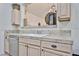 Kitchen area featuring a stainless steel dishwasher and sink with light wood cabinets and tile countertops at 18650 N 91St Ave # 3701, Peoria, AZ 85382