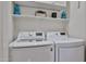 Well-equipped laundry room with modern appliances, shelving for storage, and a clean, organized space at 18650 N 91St Ave # 3701, Peoria, AZ 85382
