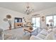 Bright living room featuring a neutral color palette, decorative chandelier, and sliding doors to the backyard at 18650 N 91St Ave # 3701, Peoria, AZ 85382