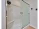 Bathroom shower featuring glass doors, a built in seat, and a clean, modern design at 18650 N 91St Ave # 3701, Peoria, AZ 85382