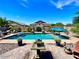 Resort-style backyard featuring a pool with lush landscaping, perfect for entertaining and enjoying outdoor living at 20592 E Reins Rd, Queen Creek, AZ 85142