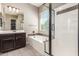Bathroom featuring a separate shower and tub, dark cabinets, a window, and tile floors at 20592 E Reins Rd, Queen Creek, AZ 85142
