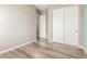 Bedroom with spacious closet, neutral walls, wood-look floors, and ample storage for comfortable living at 20592 E Reins Rd, Queen Creek, AZ 85142