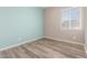 Bright bedroom with wood-look floors, a window for natural light, and stylish two-tone paint at 20592 E Reins Rd, Queen Creek, AZ 85142