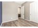 Bedroom featuring wood floors, neutral walls, and a door leading to other rooms at 20592 E Reins Rd, Queen Creek, AZ 85142