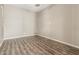 Bright, empty room with stylish vinyl floors and neutral walls at 20592 E Reins Rd, Queen Creek, AZ 85142