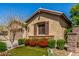 Lovely exterior featuring desert plants, artificial turf, and a two-car garage at 20592 E Reins Rd, Queen Creek, AZ 85142
