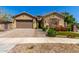 Charming single-Gathering home showcasing desert landscaping and a two-car garage at 20592 E Reins Rd, Queen Creek, AZ 85142