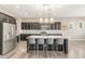 Kitchen island featuring granite counters, pendant lights, and stainless steel appliances at 20592 E Reins Rd, Queen Creek, AZ 85142