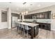 Kitchen with dark cabinetry, granite counters, stainless steel appliances, and seating at 20592 E Reins Rd, Queen Creek, AZ 85142