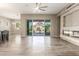Bright living room with fireplace and sliding glass doors to the outdoor pool and patio at 20592 E Reins Rd, Queen Creek, AZ 85142