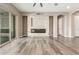 Bright living room featuring a fireplace with stone surround and wood-look flooring at 20592 E Reins Rd, Queen Creek, AZ 85142