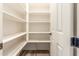 Walk-in pantry with open shelving and access door at 20592 E Reins Rd, Queen Creek, AZ 85142