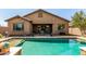 Sparkling pool surrounded by lush landscaping, offering a refreshing oasis for outdoor enjoyment and leisure at 20592 E Reins Rd, Queen Creek, AZ 85142