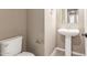 Powder room featuring a pedestal sink and modern fixtures at 20592 E Reins Rd, Queen Creek, AZ 85142