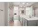 Bathroom with double sinks, walk-in shower, and view into the bedroom at 21352 N 271St Dr, Buckeye, AZ 85396
