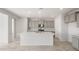 Modern kitchen with stainless steel appliances, a large island, and tile backsplash at 21352 N 271St Dr, Buckeye, AZ 85396