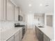 Modern kitchen with stainless appliances, tile backsplash, and quartz countertops at 21352 N 271St Dr, Buckeye, AZ 85396