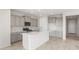 Well-lit kitchen featuring quartz countertops, stainless steel appliances, and tile flooring at 21352 N 271St Dr, Buckeye, AZ 85396
