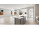 Open concept kitchen features quartz counters, kitchen island, and stainless steel faucet at 21352 N 271St Dr, Buckeye, AZ 85396