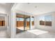 Bright living room features large windows and glass door to the backyard at 21352 N 271St Dr, Buckeye, AZ 85396