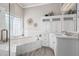 Elegant bathroom with a soaking tub, a window with privacy glass and white marble at 21474 N 56Th Ave, Glendale, AZ 85308