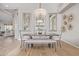 Formal dining room with stylish chandelier, elegant mirrors, and modern furniture at 21474 N 56Th Ave, Glendale, AZ 85308