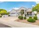 Well-maintained home featuring a manicured lawn, mature trees, and a three-car garage at 21474 N 56Th Ave, Glendale, AZ 85308