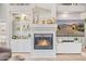 Close-up of a marble fireplace with built-in shelving and a mounted television at 21474 N 56Th Ave, Glendale, AZ 85308