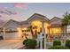 Elegant home featuring lush landscaping, a two-car garage, and classic architectural details at sunset at 21474 N 56Th Ave, Glendale, AZ 85308